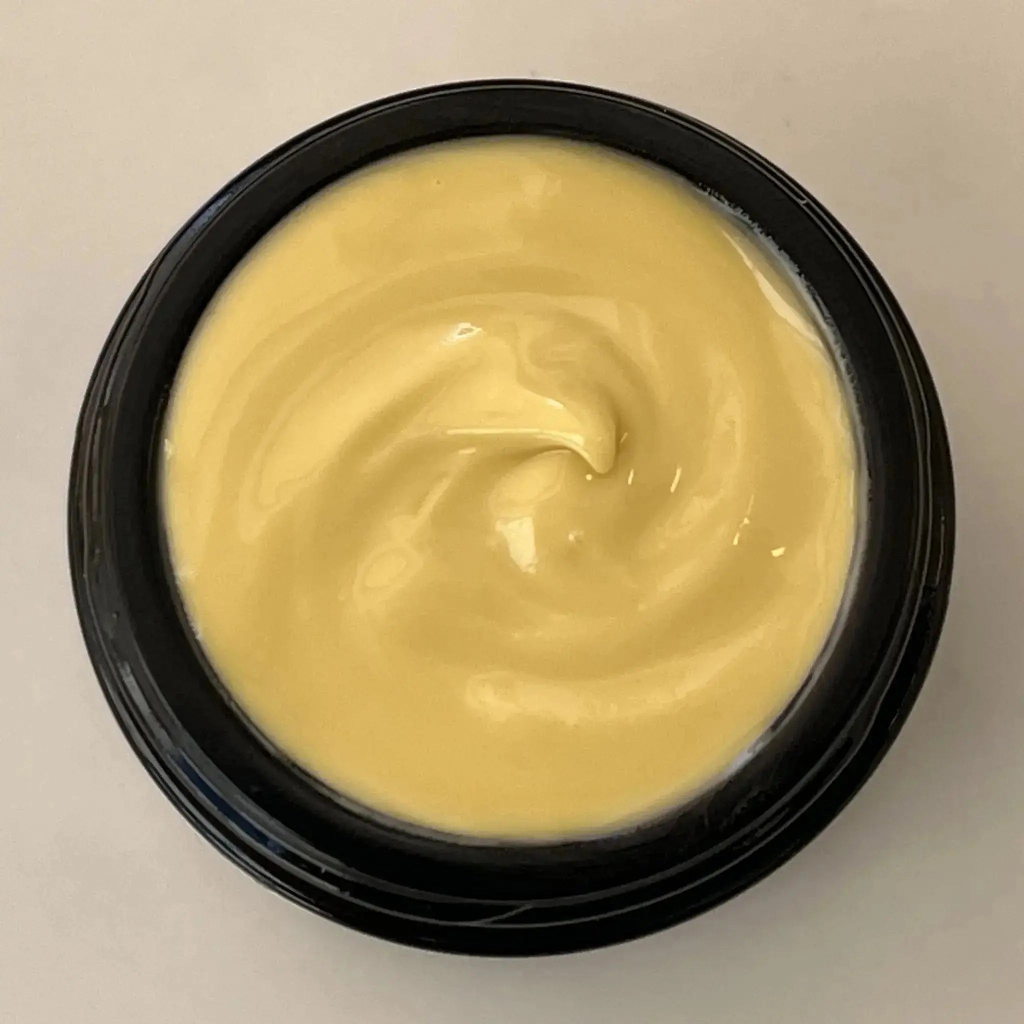 Top view of open jar of Wild Blueberry Eye Cream