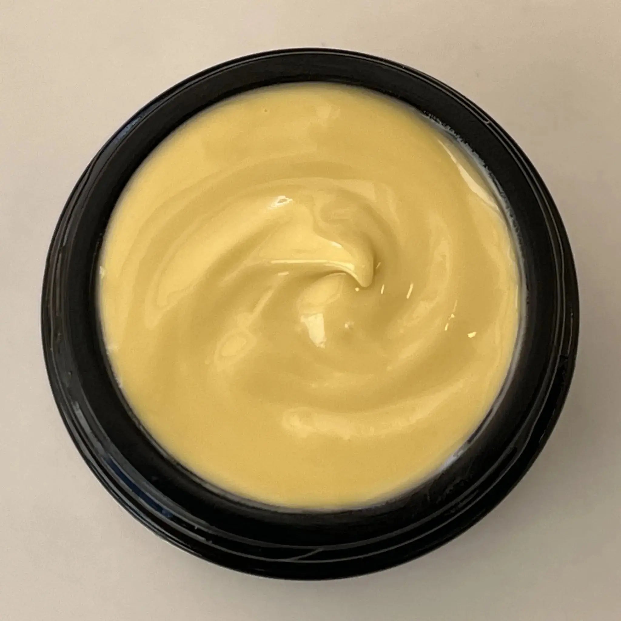 Top view of open jar of Wild Blueberry Eye Cream